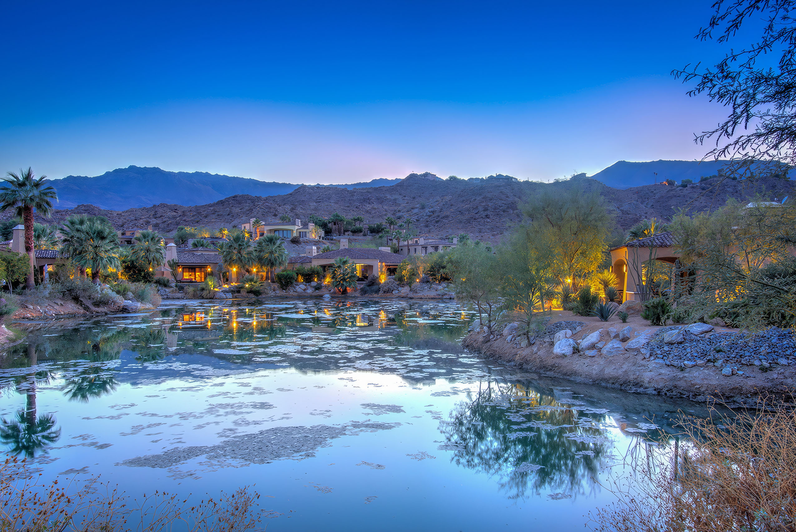 dusk beside pool with mountain backdrip and red colored sunset.